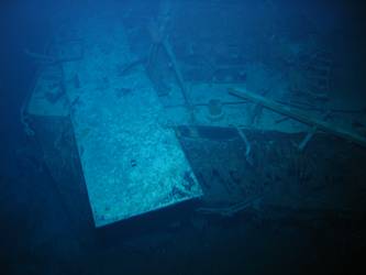 Rectangular steel plate cover lying on what could be deck house